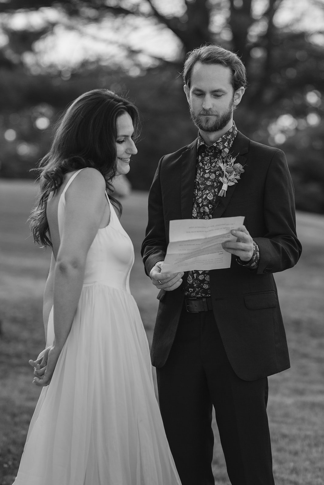 bride and groom read personal vows to each other during first look