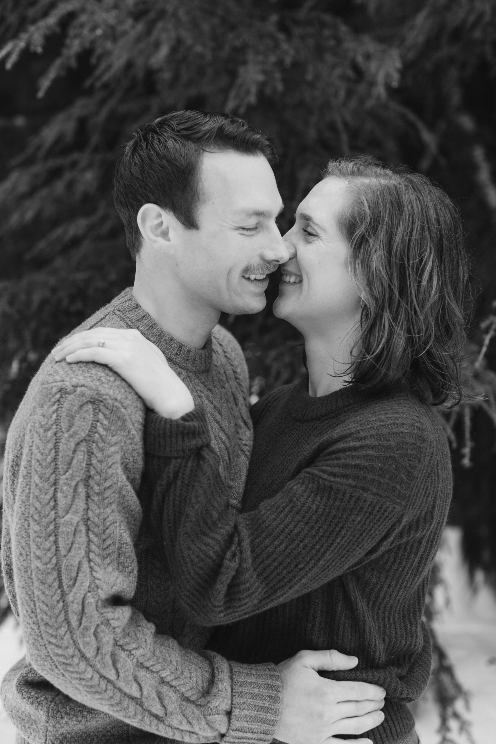 boy and girl kiss during winter engagement shoot