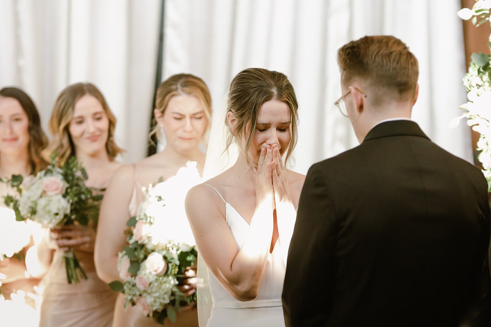bride covers her mouth from emotion during ceremony at sodo park