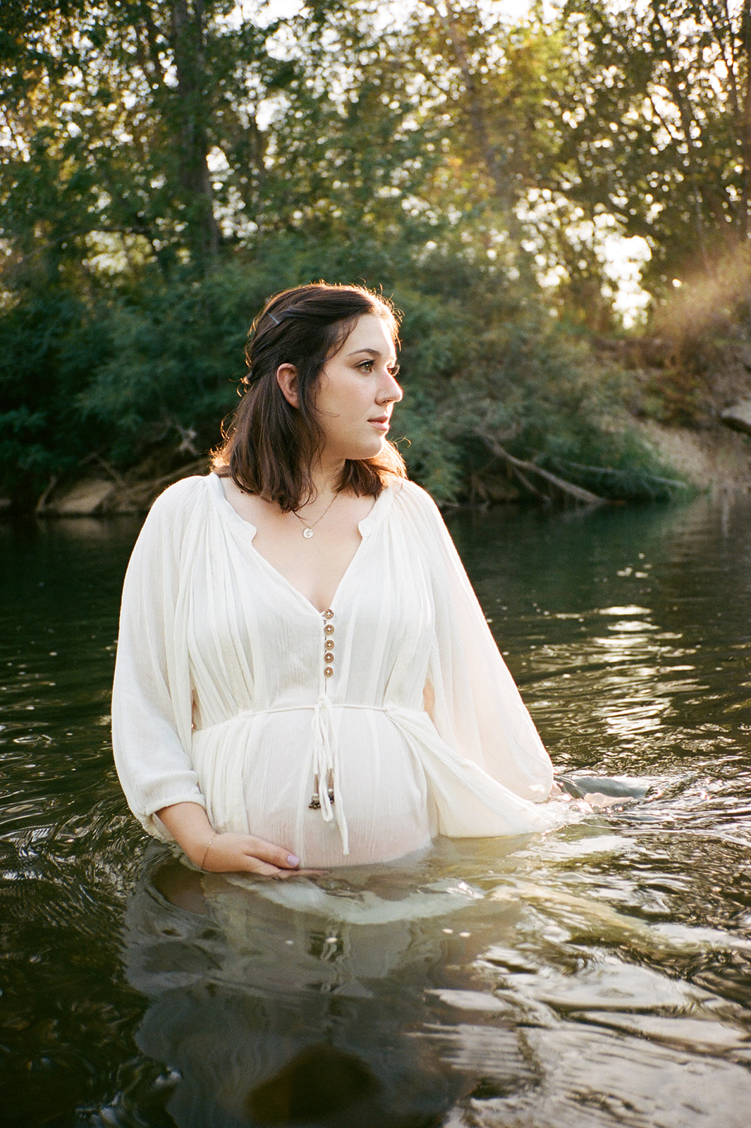 pregnant woman standing in boise river